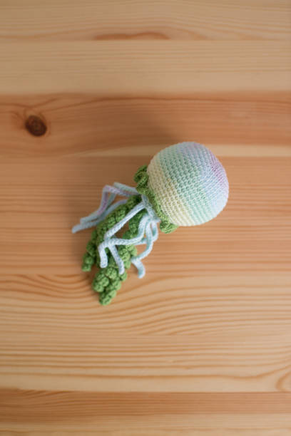 istock Handmade crocheted octopus on a wooden background. handmade. 1527116186