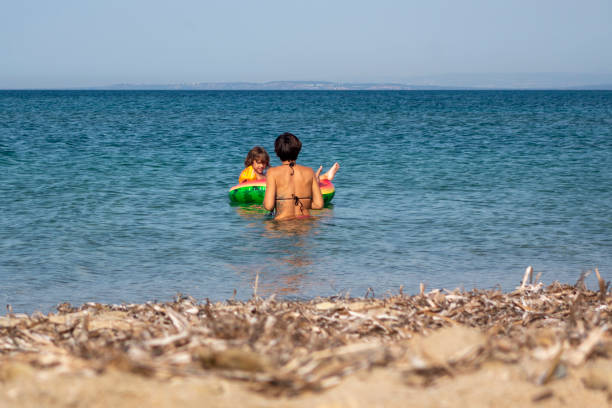 istock Boy playing with swim ring in the sea. 1527189986