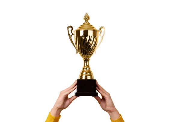 istock female hands holding golden trophy  isolated on white background 1527192119