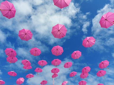 pink umbrellas against the sky