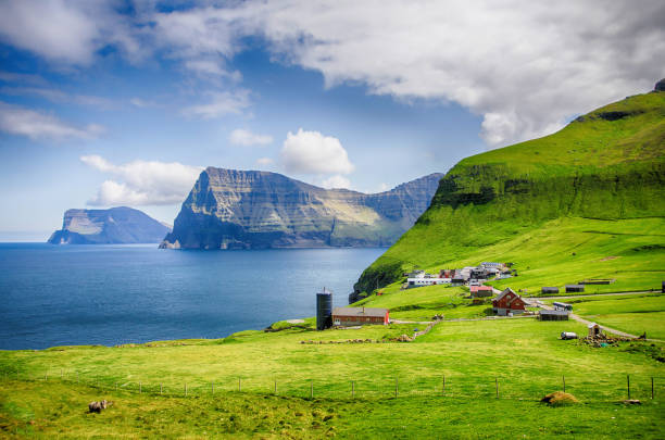 The island of Kalsoy hiking to Kallur Lighthouse, Faroe Islands The island of Kalsoy hiking to Kallur Lighthouse, Faroe Islands green valley denmark stock pictures, royalty-free photos & images