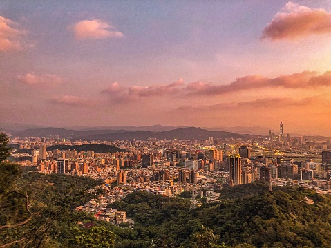Landscape Golden hour on top of the jinmian mountain taipei with city view and trees under the clear sky with white clouds
