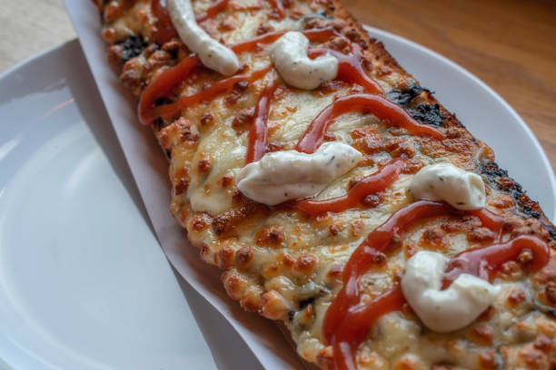 istock Long polish zapiekanka, generously filled with various toppings. 1527286888
