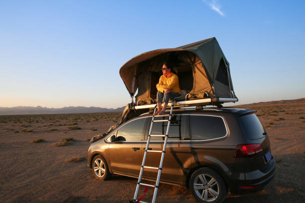 A Chinese woman camping on a car