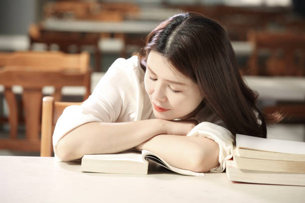 istock A Chinese girl reading in a library 1527348613