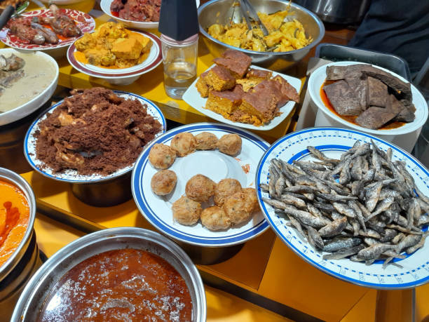 istock Assorted Cuisine Padang Kapau dishes displayed in a Minang restaurant including Rendang Sapi, Ayam Goreng, Perkedel Potato, Paru Sapi, Gulai Nangka, Gulai Tauco Padang with tenggiri fish, Terong Balado and many other dishes. 1527358776