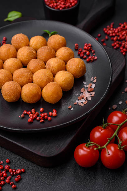 istock Delicious fried potato balls with breaded mozzarella, salt, spices and herbs 1527366818