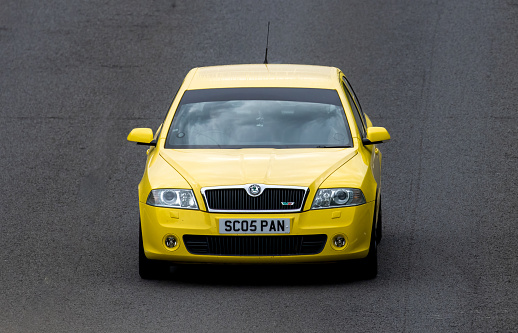 Milton Keynes,UK - July 9th 2023:  2007 yellow SKODA OCTAVIA car travelling on a UK main road
