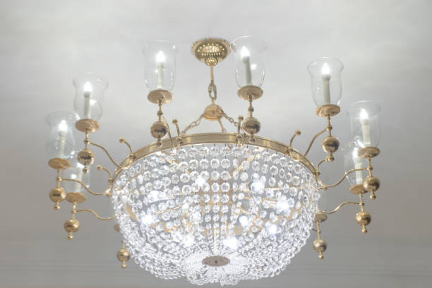 istock Chandelier white crystal ceiling lamp with candle lamp on white painted ceiling wall 1527428478