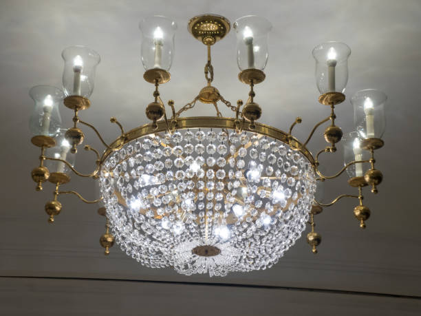 istock Chandelier white crystal ceiling lamp with candle lamp on white painted ceiling wall 1527428485