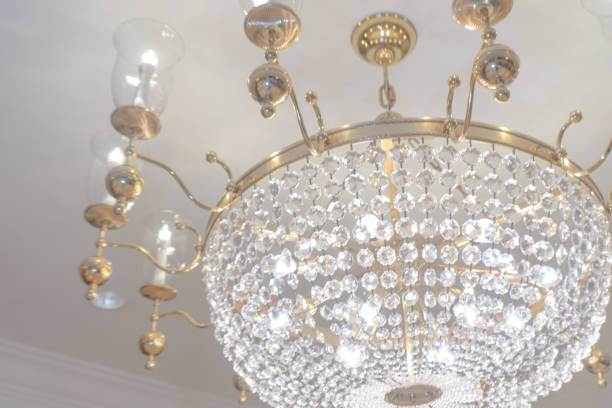 istock Chandelier white crystal ceiling lamp with candle lamp on white painted ceiling wall 1527430646