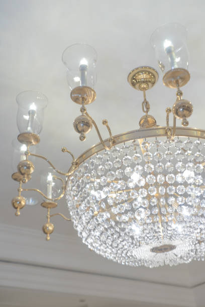 istock Chandelier white crystal ceiling lamp with candle lamp on white painted ceiling wall 1527432252