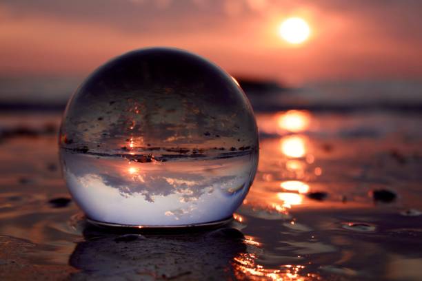 istock Crystal ball on beach during sunrise 1527445387