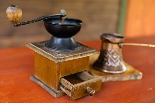 Close-up of an old hand-cranked corn peeling machine as decoration in a cozy loft living room. This photo was taken in a loft in the small village of Ambronay, in the Ain department in the Auvergne-Rhone-Alpes region in France.