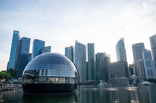Singapore - 20 October 2022: Apple Marina Bay Sands with a view of cityscape. The World's First Floating Apple Store, designed by Foster + Partners