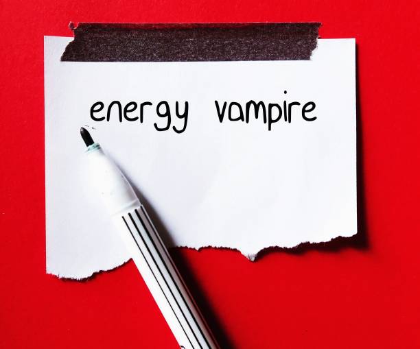istock Torn note stick on red wall with handwritten text ENERGY VAMPIRE, means someone who intentionally drain our emotional energy, draw us into a conversation that leaves feeling exhausted 1527547846