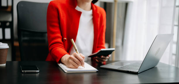 istock businesswoman hand working with new modern computer and writing on the notepad strategy diagram as concept in office 1527612952