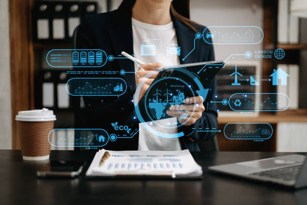 istock Businesswoman working virtual tablet computer twith reduce CO2 concept with icons, global warming such as reforest green factory recycle in office 1527612973