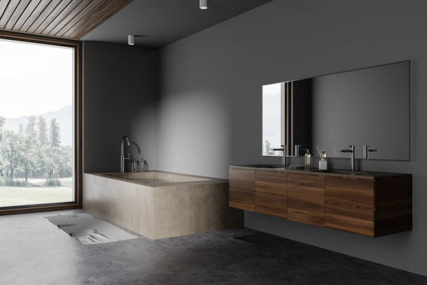 istock Gray bathroom corner with massive tub, window and double sink 1527621440