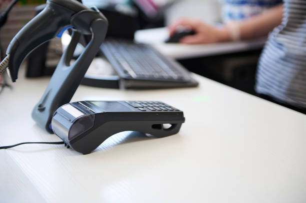 istock Selective focus. A countertop with credit card reader and barcode scanner in a store. 1527639538