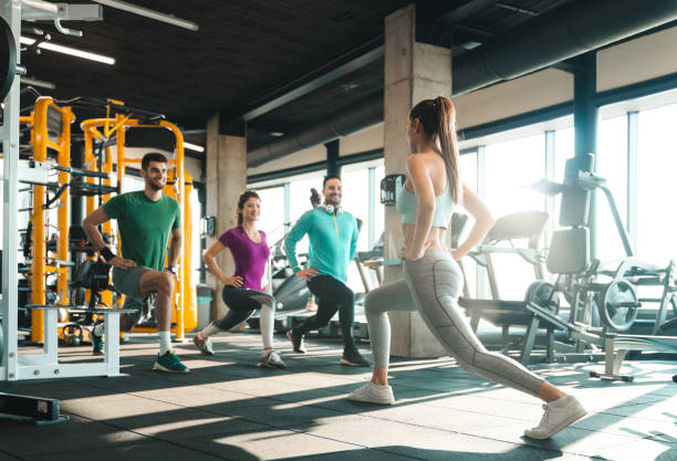 istock Cheerful young athletes doing lunges in gym 1527652338