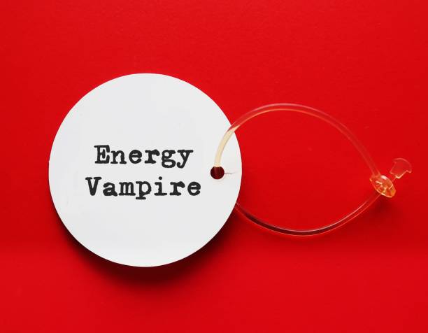 istock White tag on red background  with text written ENERGY VAMPIRE, means someone who intentionally drain our emotional energy, draw us into a conversation that leaves feeling exhausted 1527700029