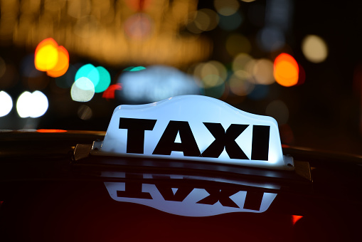 Tokyo, Japan - November 6, 2010: Taxi driver driving customers with taxi at night Hamamatsucho district, Tokyo, Japan.