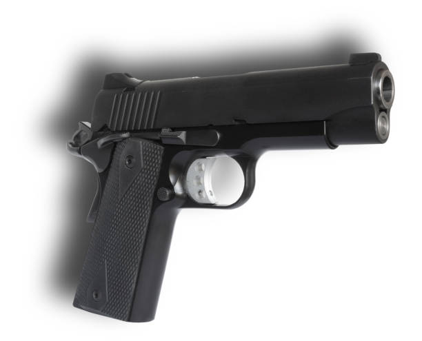 istock Shadow behind a 1911 semi auto handgun 1527755551