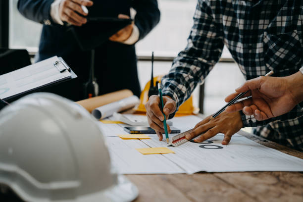 istock Architecture and teamwork concept. Male engineers or business partners on a construction site, discussing project details. 1527761338