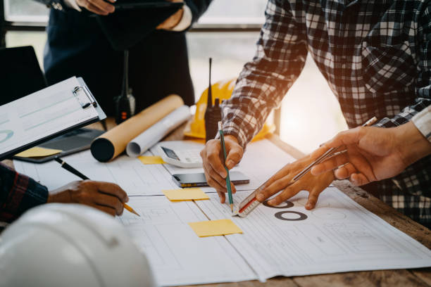 istock Architecture and teamwork concept. Male engineers or business partners on a construction site, discussing project details. 1527761341