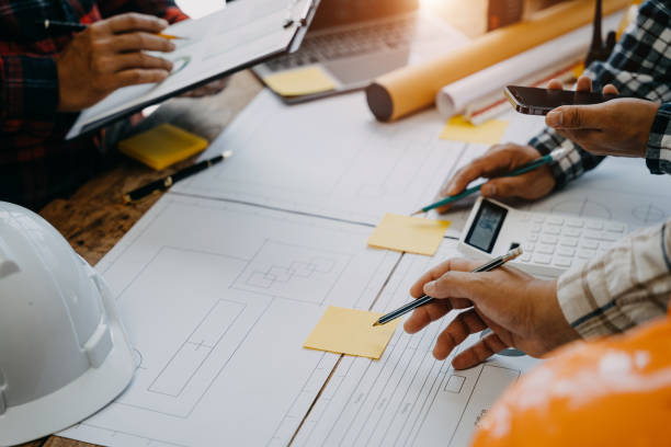 istock Architecture and teamwork concept. Male engineers or business partners on a construction site, discussing project details. 1527761352