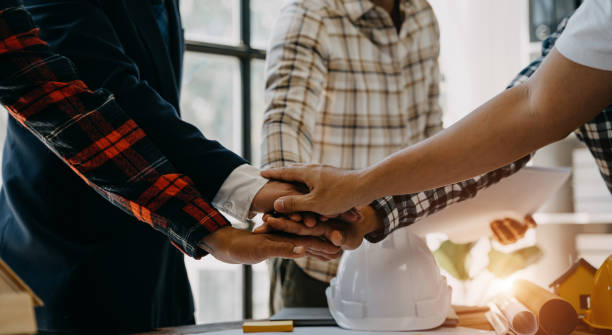 istock Team architects workers,  join hands to join forces to join forces to work for the industry for success. Teamwork and professional colleagues : Workers' hands, teamwork concept. 1527761381