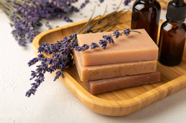 istock Natural soap with lavender extract. Handmade soap with lavender flowers on a white texture background. spa and relaxation concept.Aromatherapy.Flat lay.Place for text.Place for copy. 1527764079