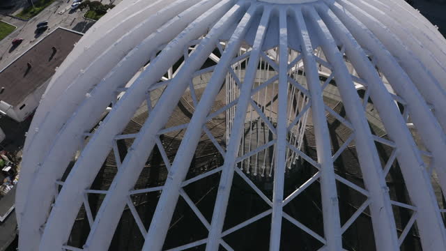 Aerial view of a lattice openwork structure consisting of semi arches. Stock footage. Modernism in architecture