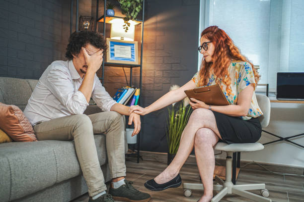 istock Female psychotherapist consoling her sad male patient while crying 1527793650