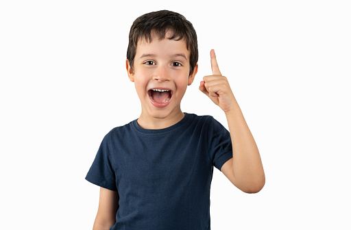 Portrait of a excited child pointing with white background. Horizontal composition.