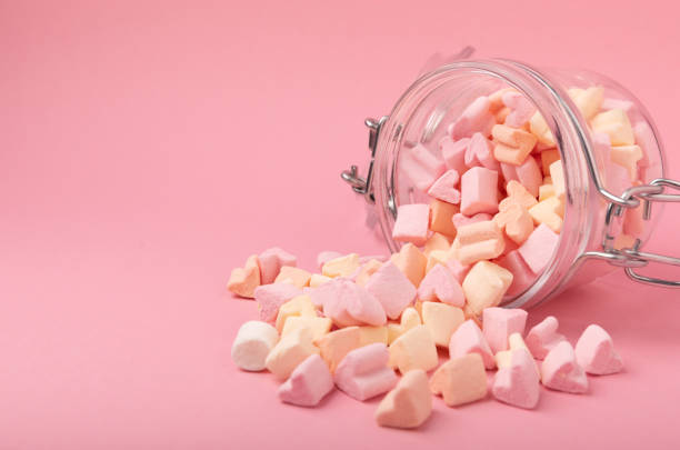 istock Marshmallows on a pink background in a glass bowl. White marshmallow flat lay. Sweets and snacks for a snack. Chewing candies close-up. Copy space. Place for text. Winter food concept. 1527842622