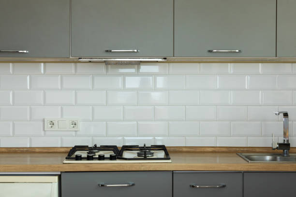 istock Blurred background of modern comfortable kitchen interior.Modern housing rental or new apartment sale.Light kitchen with cabinets and gas stove.Minimalist style.blank space.Real estate concept. 1527846281