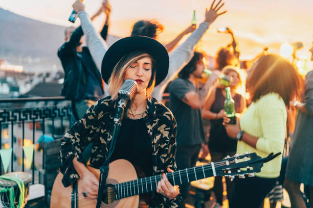 istock Friends enjoying a guitar performance on the rooftop 1527852504