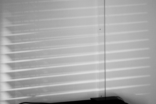 An example of camera obscura: Window blinds reflected on a wall.