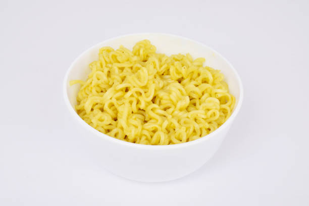 istock Cooked yellow noodles in bowl on white background 1527887663