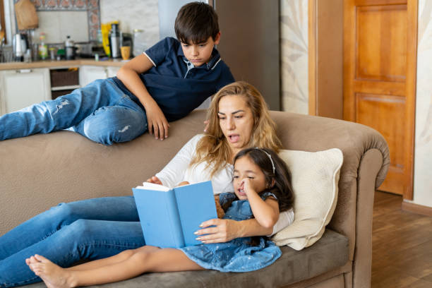 istock Mum reading a story to her children 1527900221