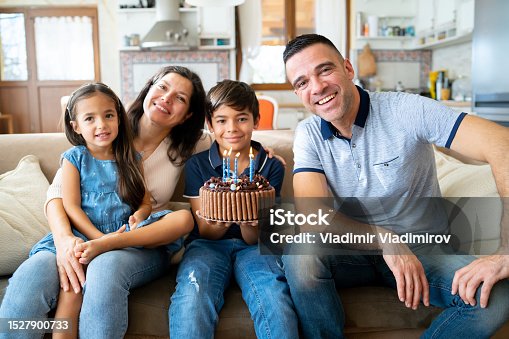 istock Family celebrating their son's birthday with cake 1527900733