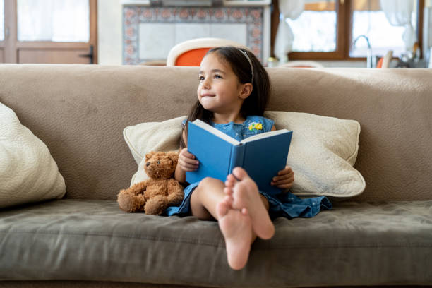 istock Small girl with story book 1527900743