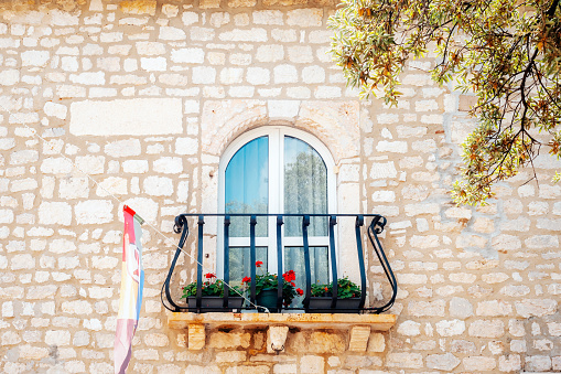 Window and balcony, beautiful old architecture. Rab island, Croatia.