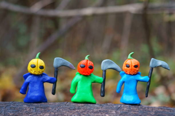 istock Ghost figures with colorful pumpkins. Halloween decorations. 1527919391