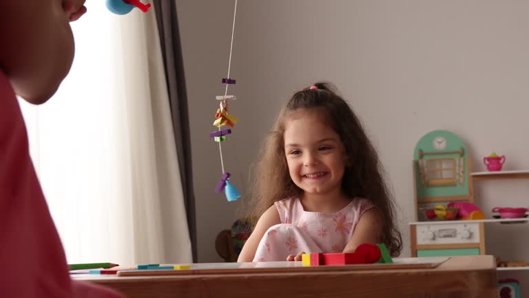 Little girl playing with her mother