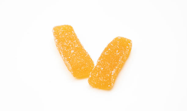 istock Two orange chewy gummy sticks sprinkled with sugar isolated on white background 1527966312