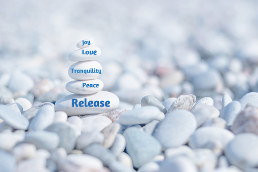 Zen stones with words Release, Peace, Tranquility, Love, Joy