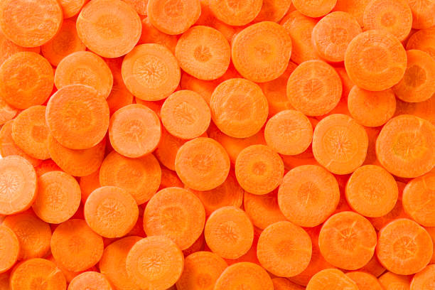 istock Carrot slices arrangement in a row composition full frame vegetables 1527995960